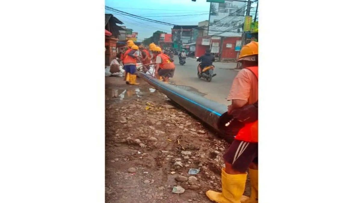 Para pekerja memasang Jaringan Distribusi Utama (JDU) air bersih PDAM Tirta Raharja di wilayah Desa Rancamanyar, Kabupaten Bandung, Jawa Barat. Foto:istimewa/